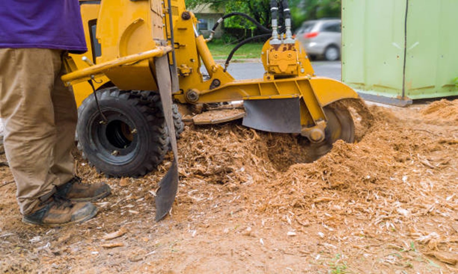 Stump grinding machine removing tree stump and wood chips in residential yard in Streetsboro Ohio